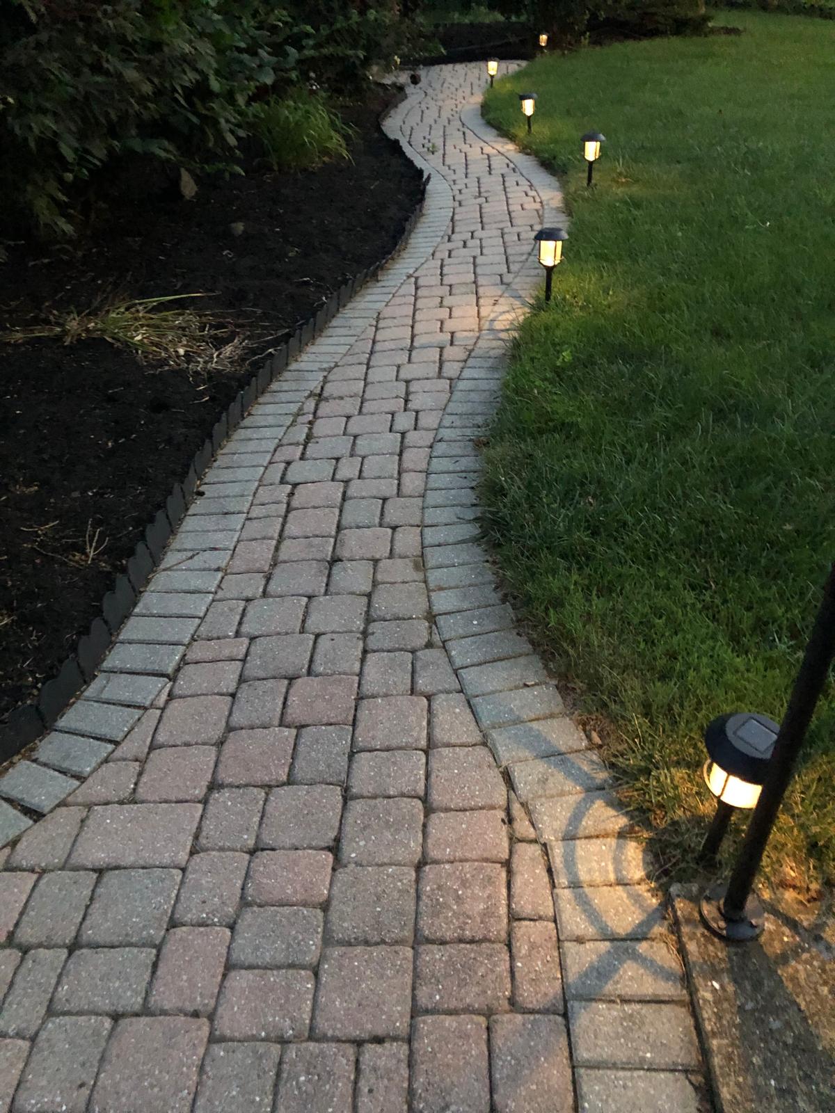 An illuminated path receding into darkness, used here as a symbol of the movement from obscurity toward understanding