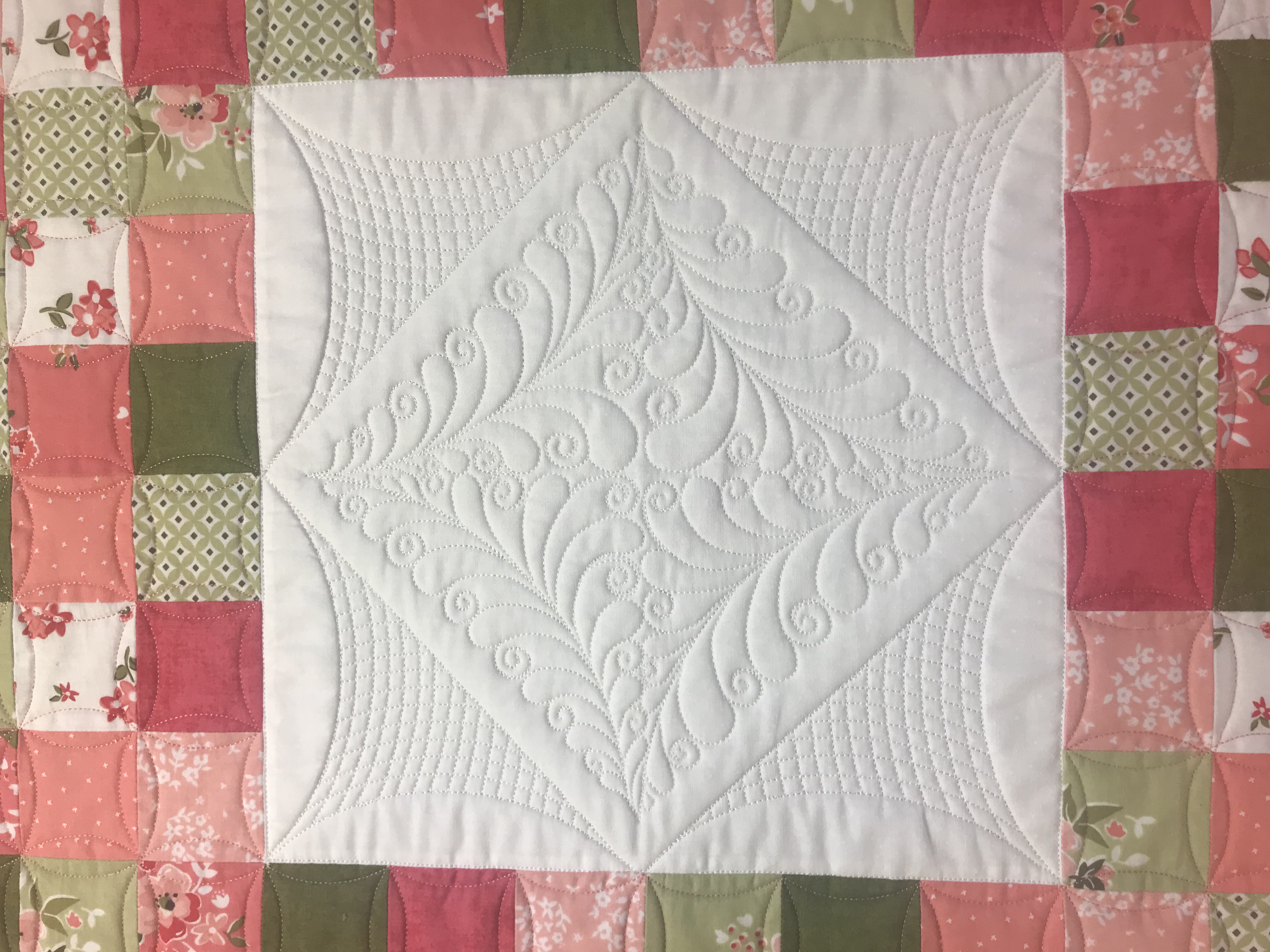 Quilt top finished with hand-guided custom quilting