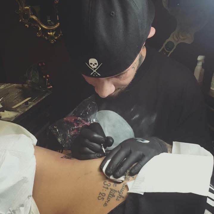 Founder Justin Woleslagle tattooing