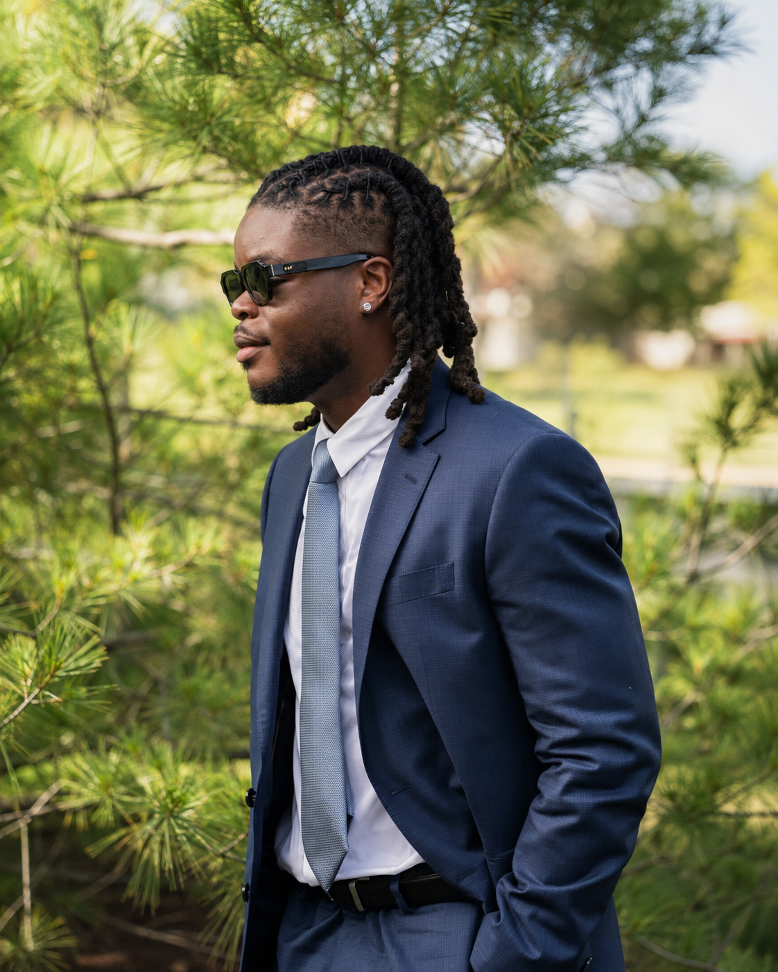 Robor Okpu in a blue suit outdoors