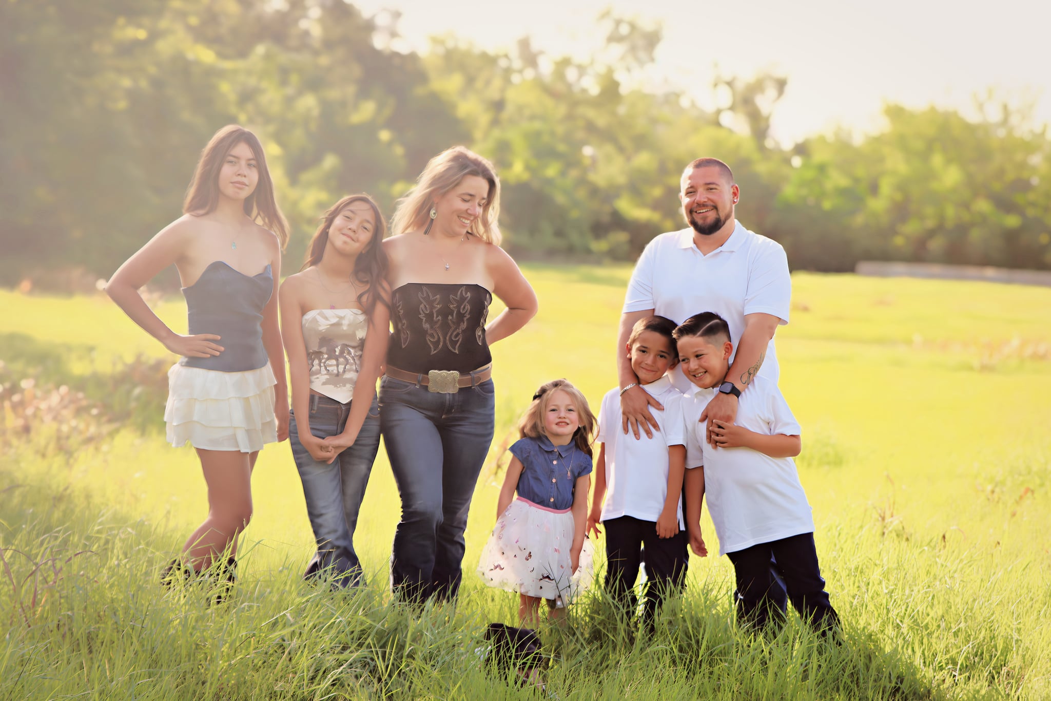 Family portrait session in a sunlit field