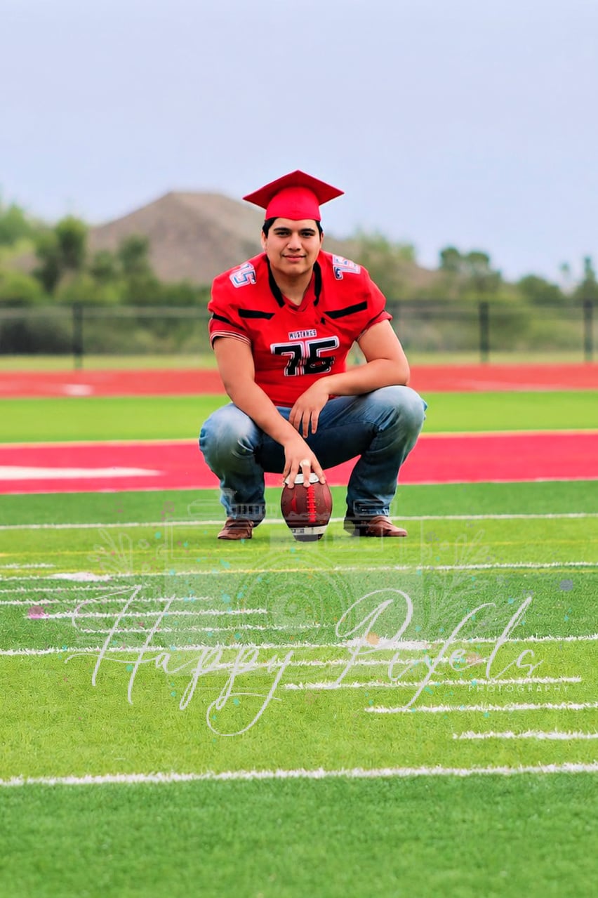 Senior graduate portrait on a football field