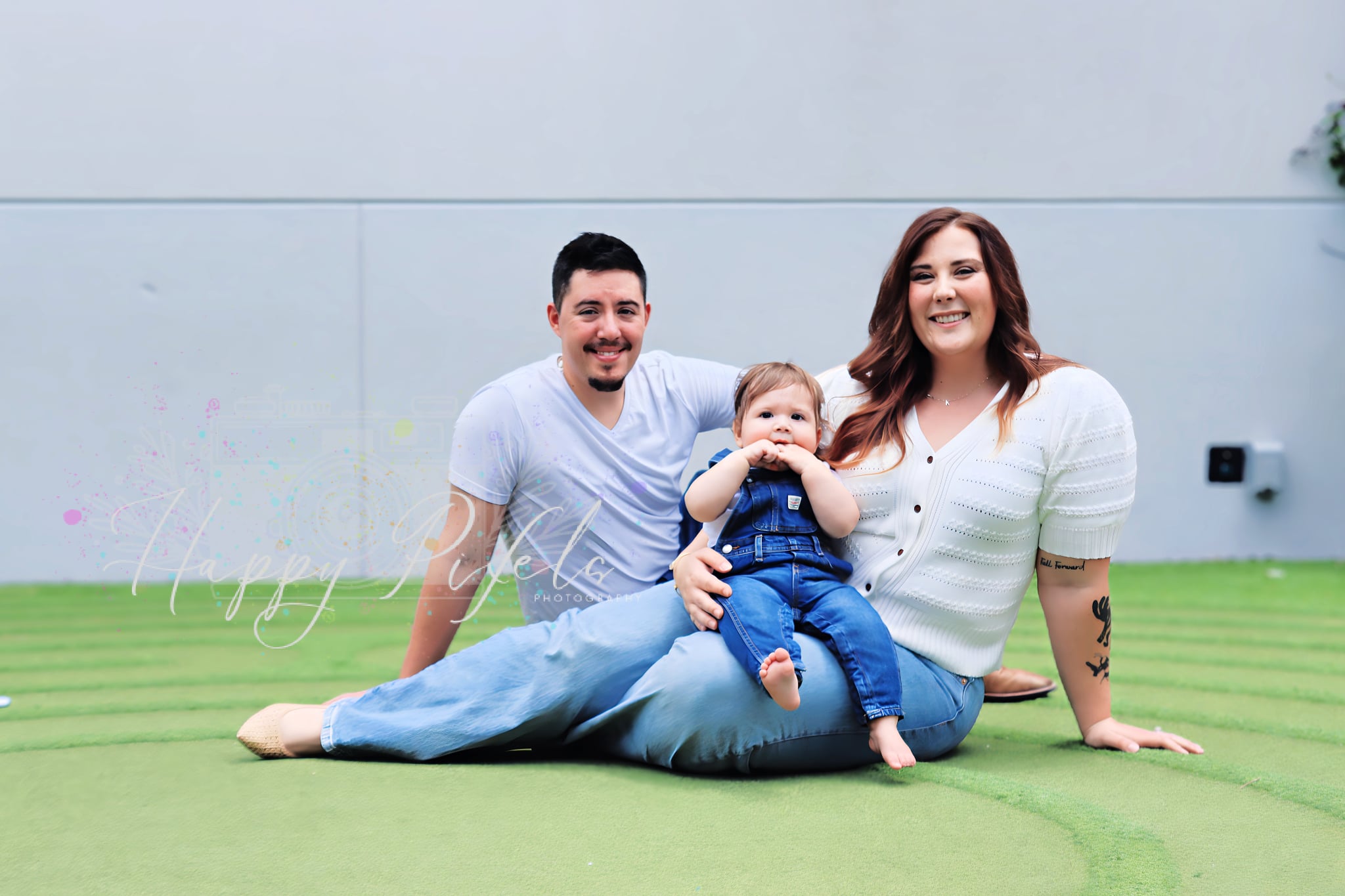 Parents seated with their baby during a family session