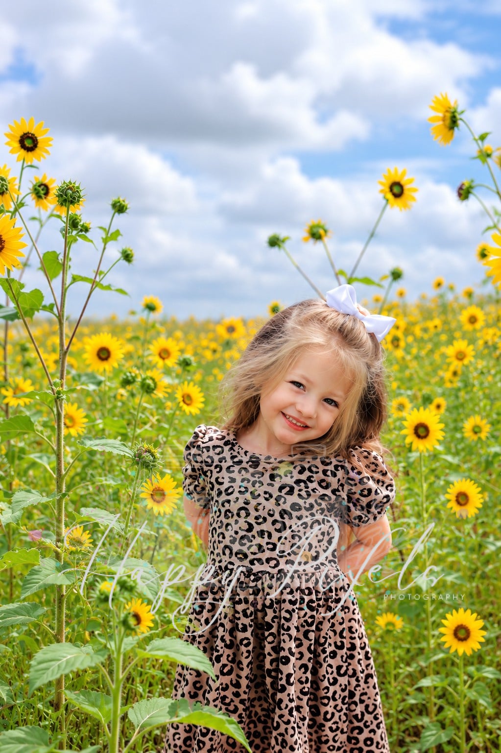 Child photographed in a field of sunflowers