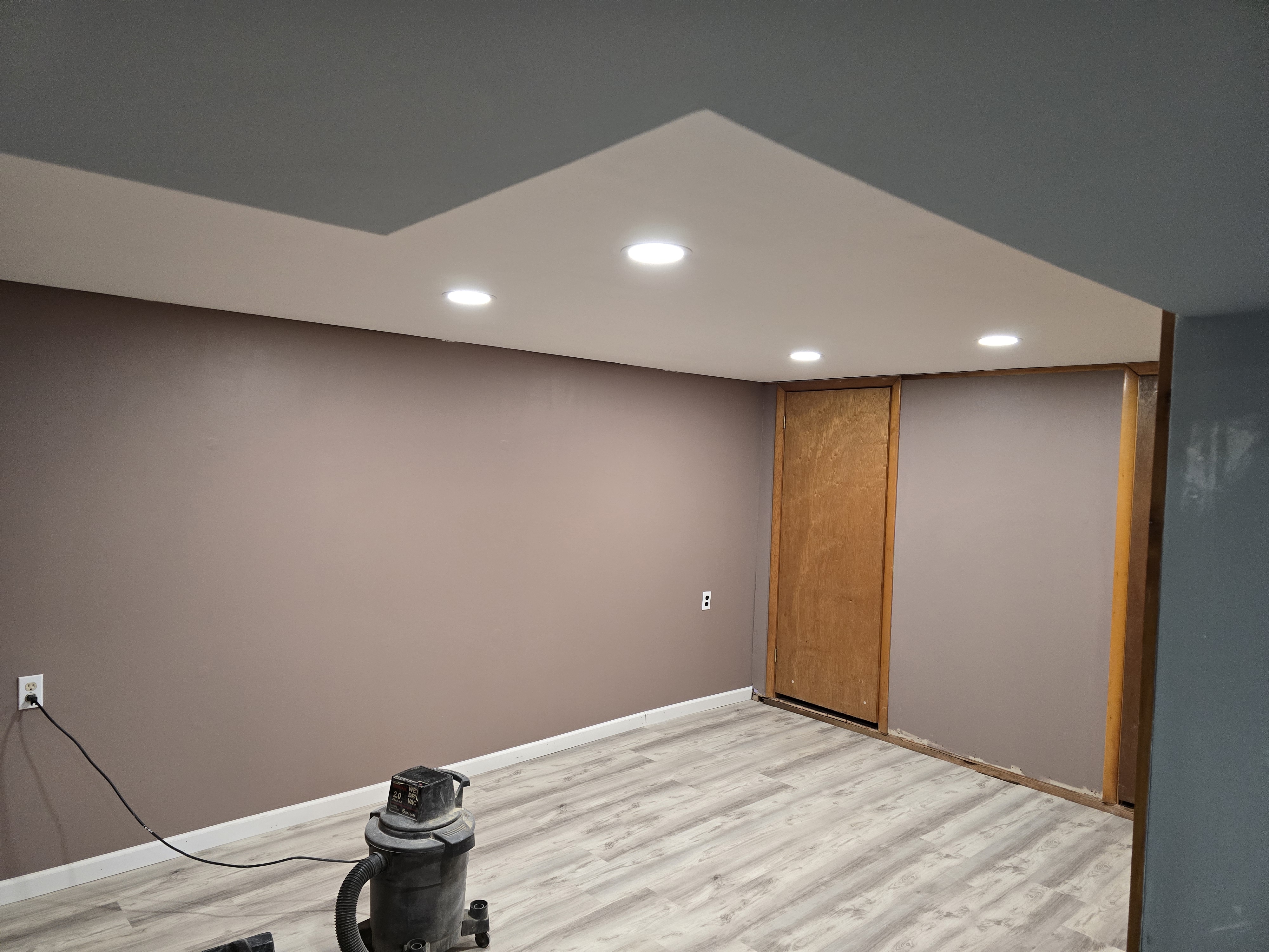 Basement remodel with finished flooring and lighting