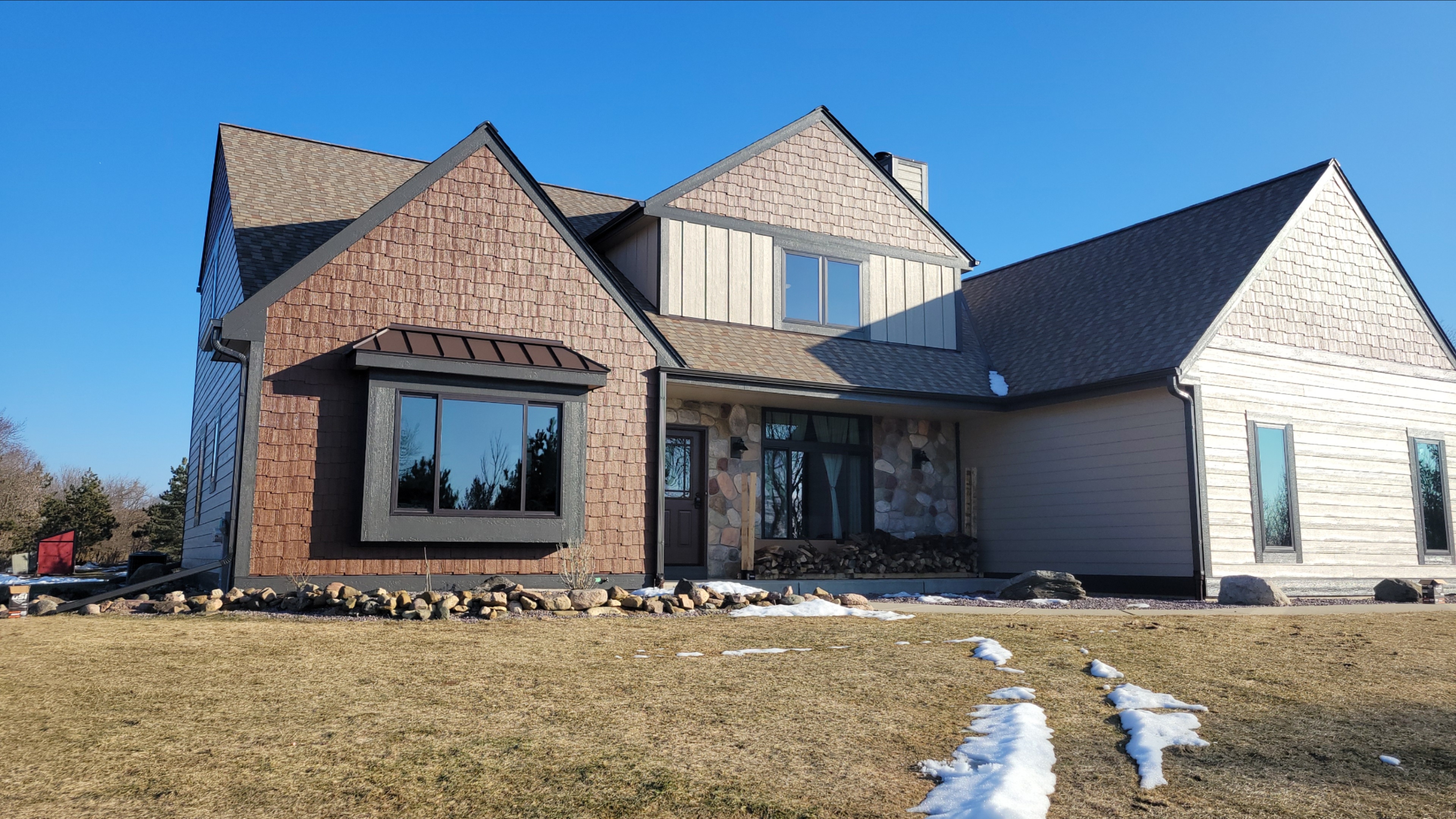 Standing seam metal accent roof over a front entry