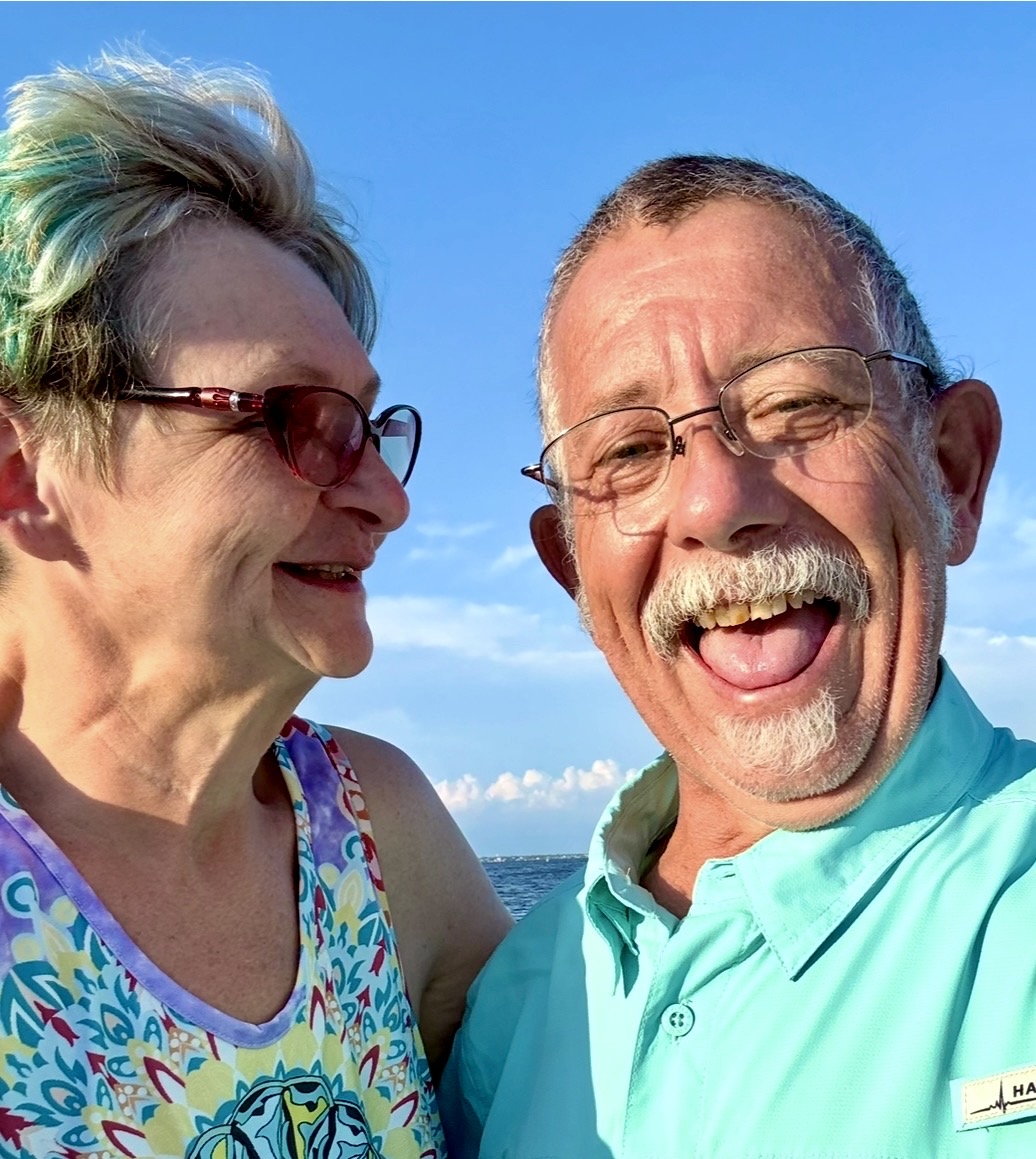 George and Emily laughing together by the lake