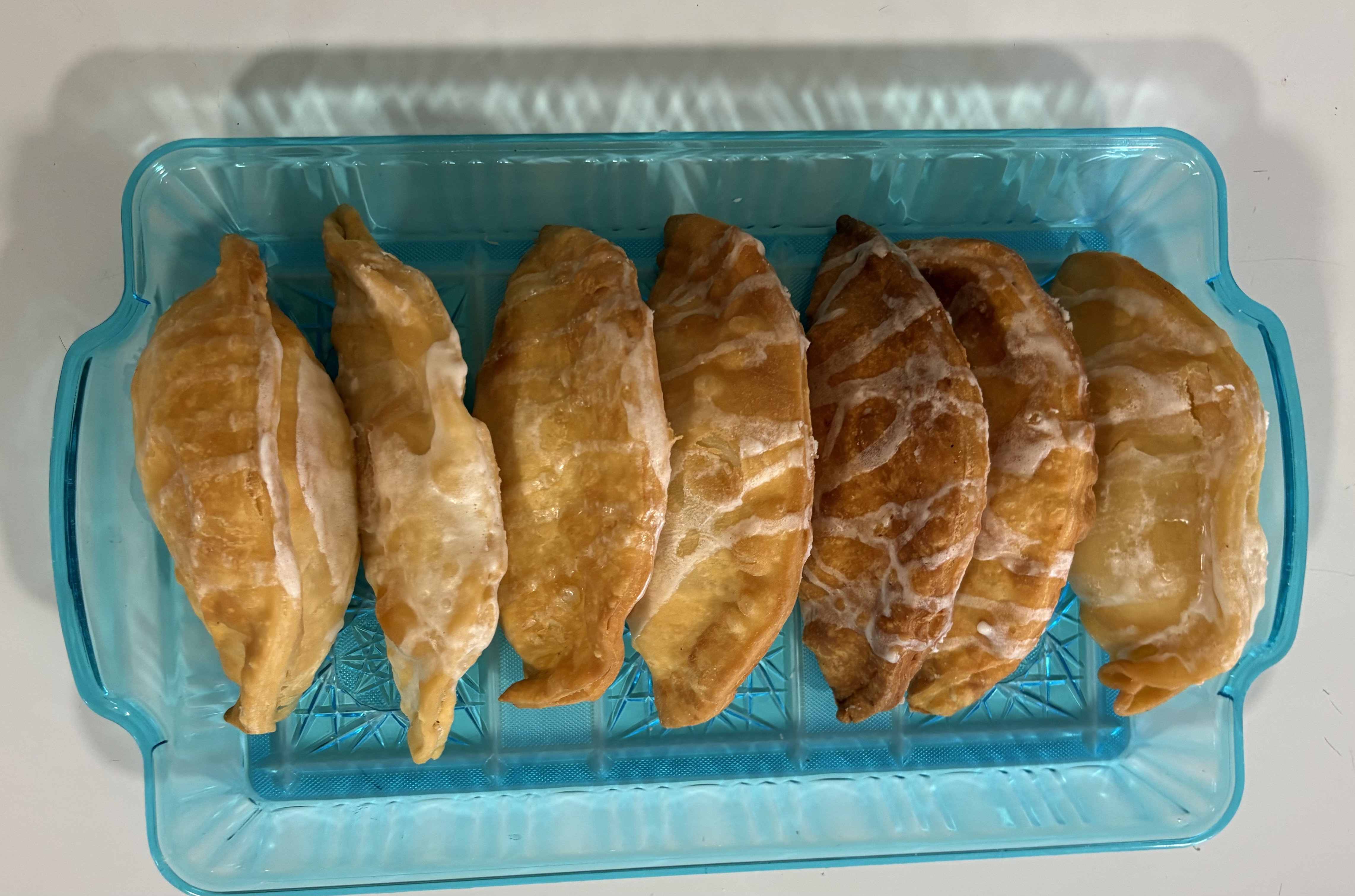 Homemade fried pies in a turquoise tray