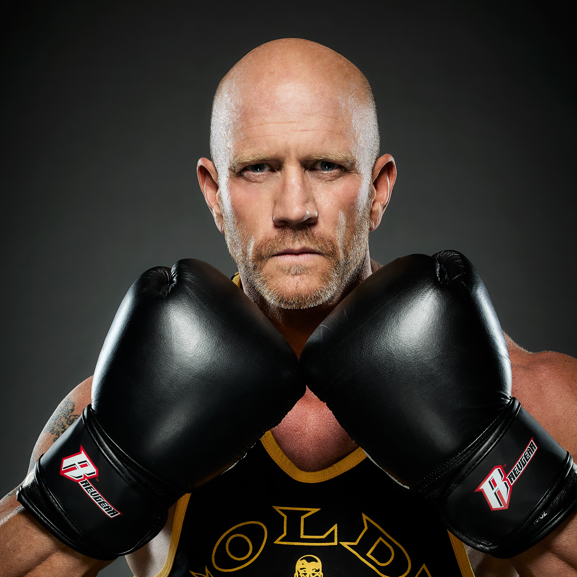 James Burbage wearing boxing gloves in a studio portrait