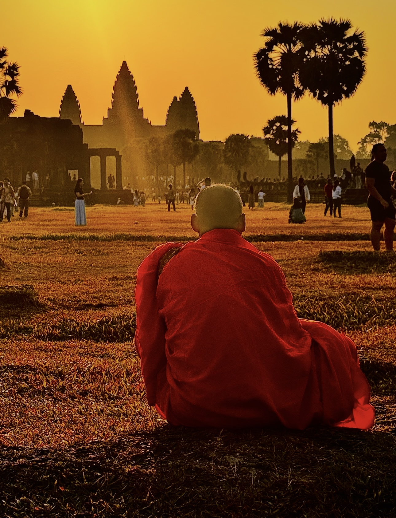 Angkor Wat silhouette against a fiery orange sky