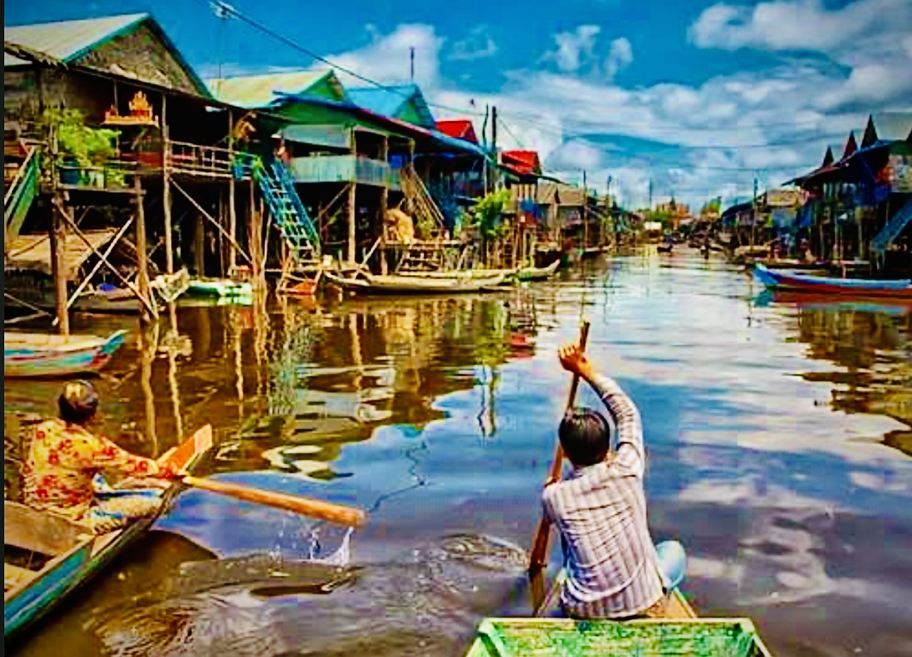 Boat passing the stilt houses of Kampong Phluk floating village