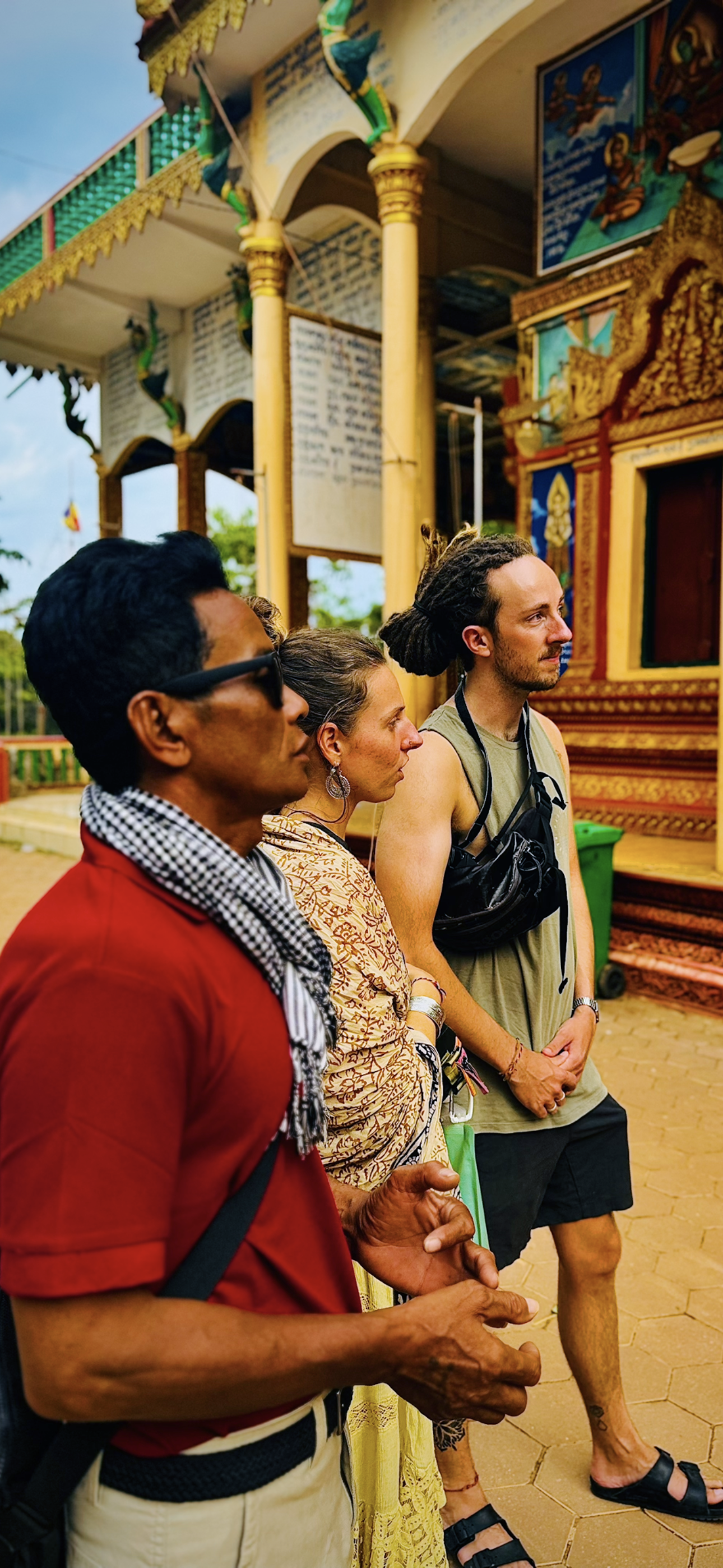 Local guides welcoming guests at a temple pavilion