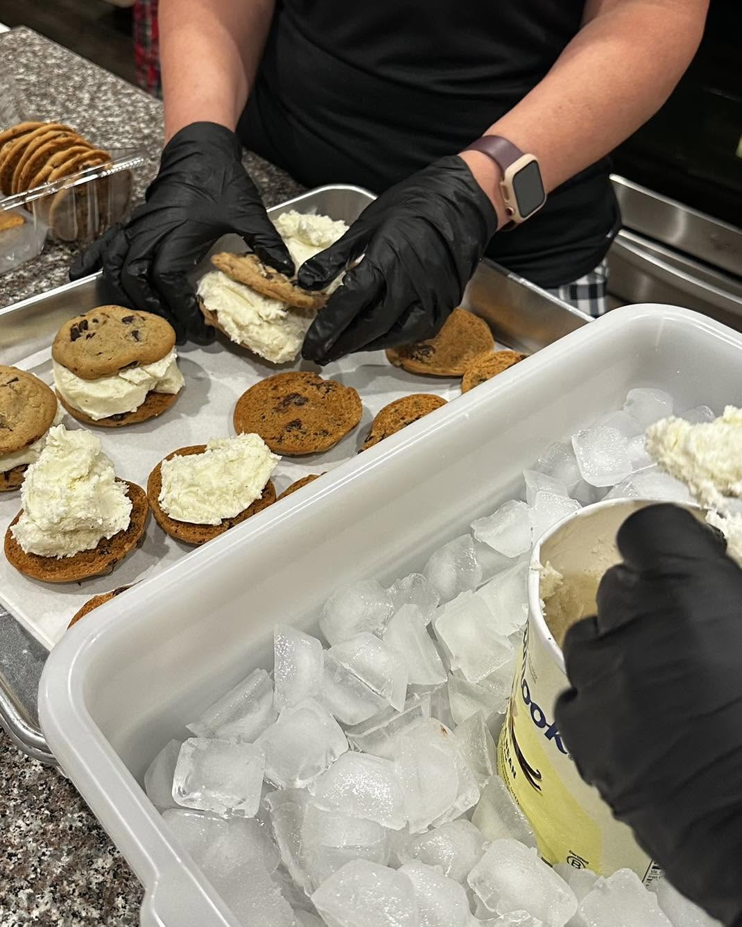 Hands assembling ice cream cookie sandwiches