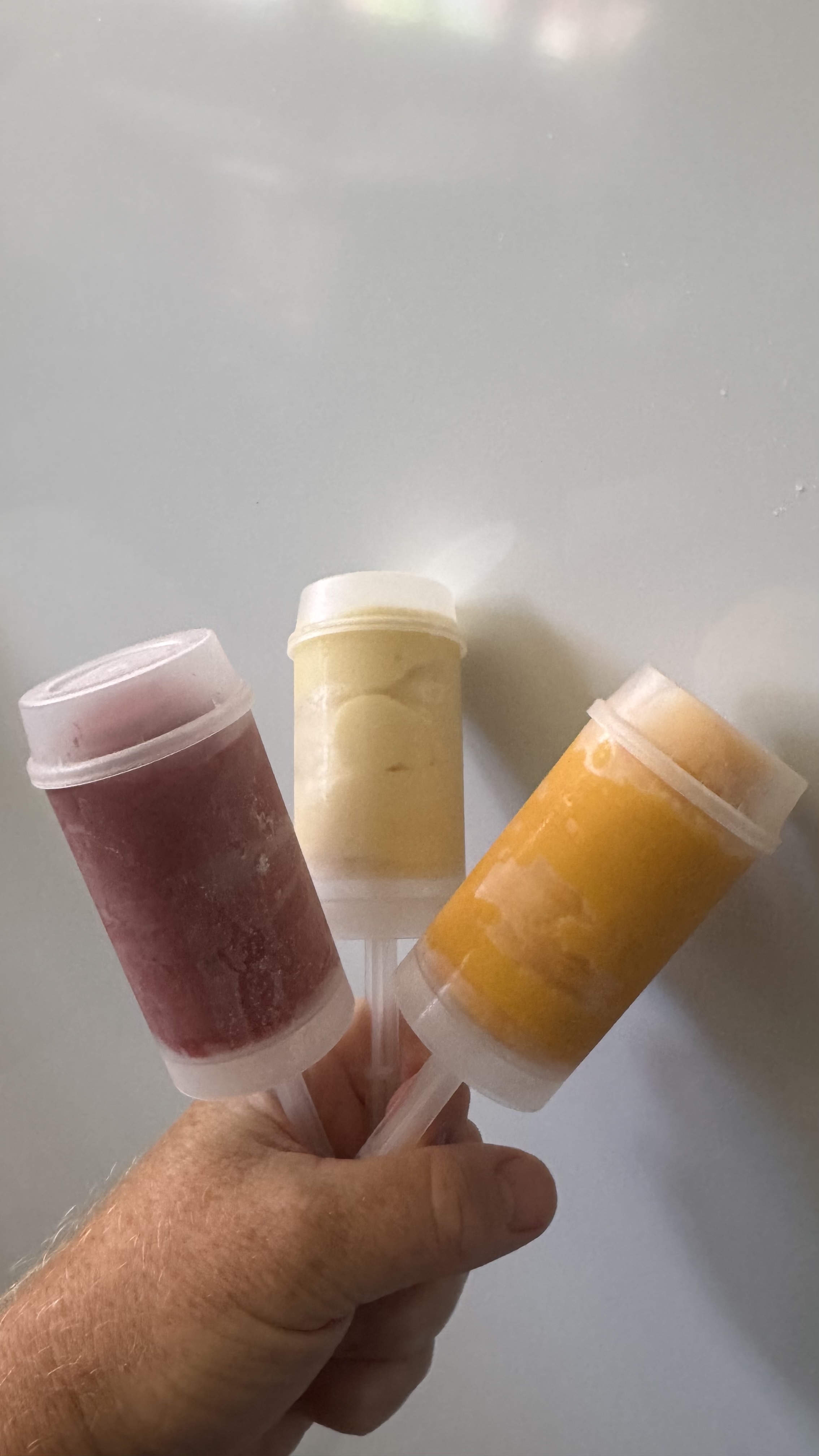 Colorful sorbet push-pops in-hand