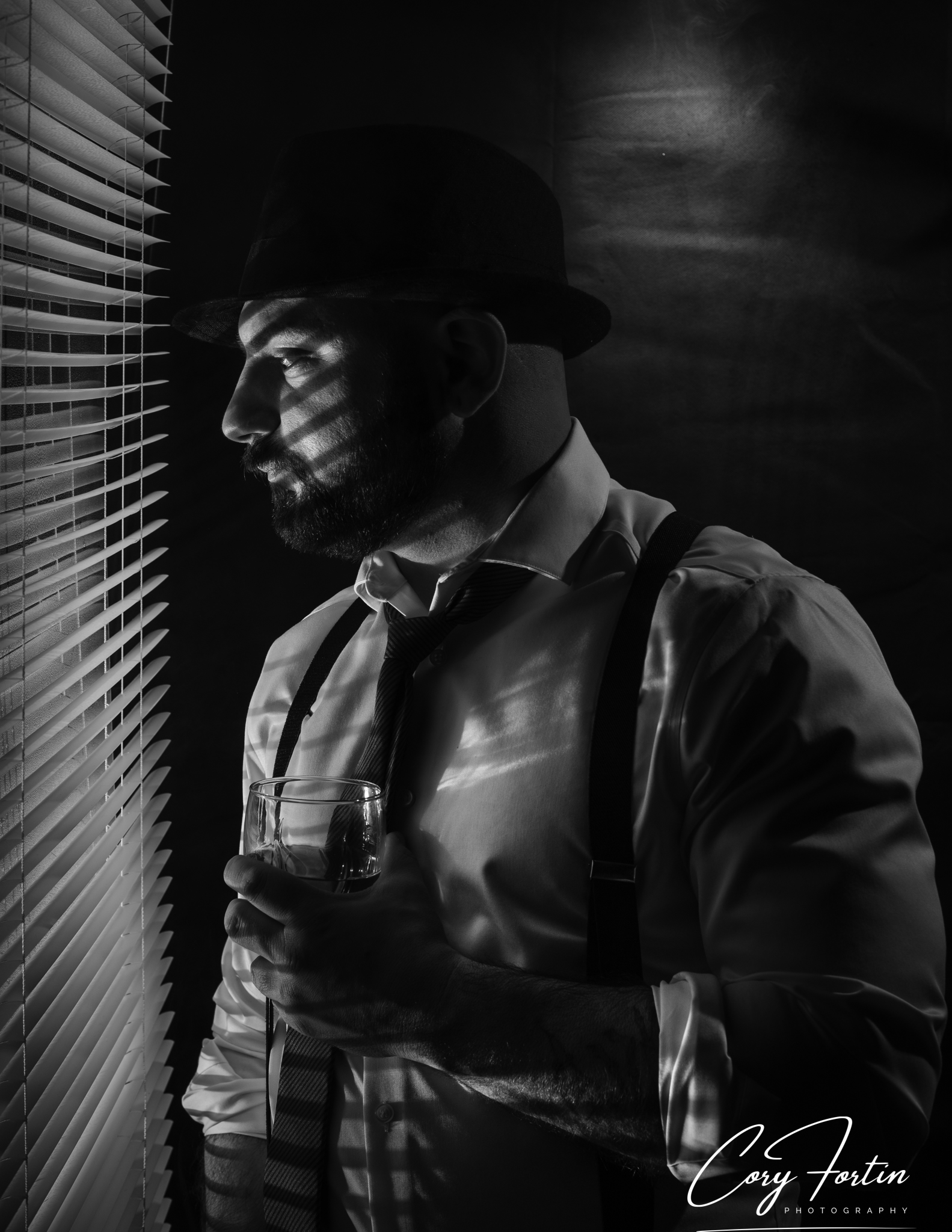 Black and white portrait of a man in dramatic window light