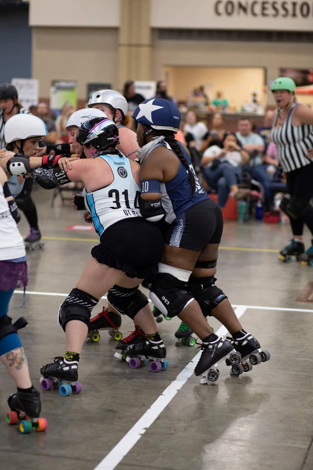 Roller derby skaters competing at an indoor event