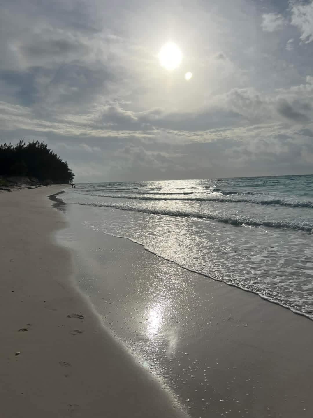 Sunlight over a quiet beach and ocean
